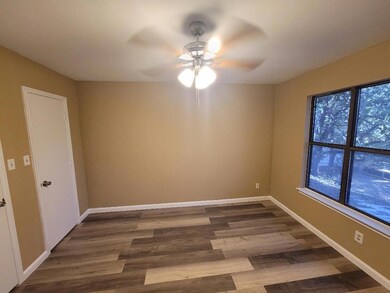 Unfurnished room with baseboards, a ceiling fan, a
