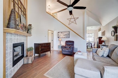Living room featuring a patterned tile surround fi