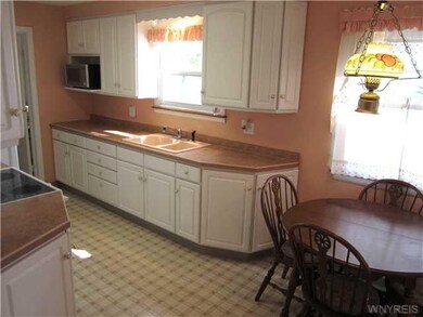 Kitchen KIT w/white raised paneled cabinets, shelf