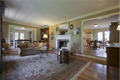 House is now vacant.  Photo shows furnished formal living room with fireplace open to dining room and friendly country kitchen.  Great for entertaining.  