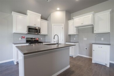 Kitchen with a kitchen island with sink, appliance