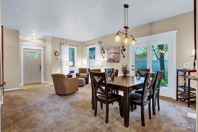 Carpeted dining space with healthy amount of natural light and a textured ceiling
