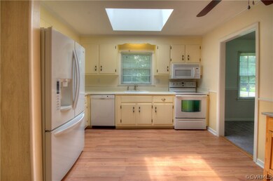 Nice Size Eat-in Kitchen has Ceiling Fan w/Light, Skylight, Smooth Top Range, Blt-in Microwave and Bosch Dishwasher, LG French Door Refrigerator with Freezer at the Bottom and Water Dispenser on Door!