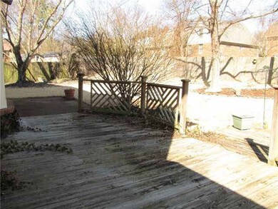 The backyard features a wood privacy fence, landsc