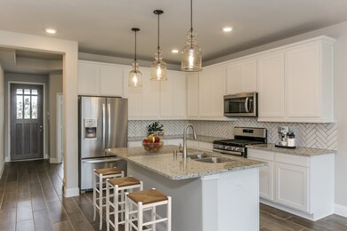 **Home is Under Construction. The photo shown here is of a completed home that has the same floor plan and similar elevation. Options and color selections may vary.**