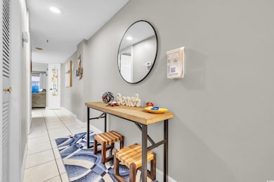 Hall with baseboards, recessed lighting, and light