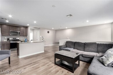 Living area with recessed lighting, visible vents,