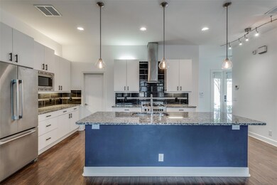 Kitchen featuring dark wood-type flooring, light s
