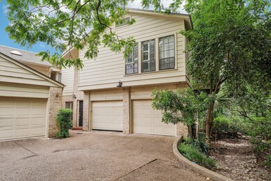 View of front of home with brick siding, driveway