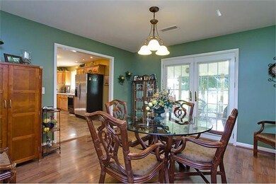 Breakfast room offers easy casual dining with french doors to the covered back patio-Hardwood flooring, plus laundry room-pantry off of breakfast room