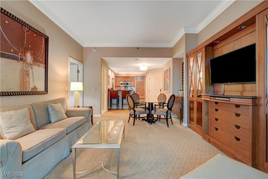 Living room with ornamental molding and light carpet