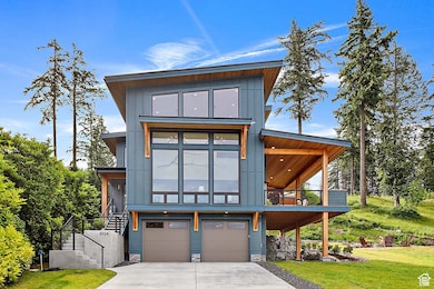 Only an Example Of what can be built on this Lot! Contemporary house featuring stairway, a garage, board and batten siding, and driveway