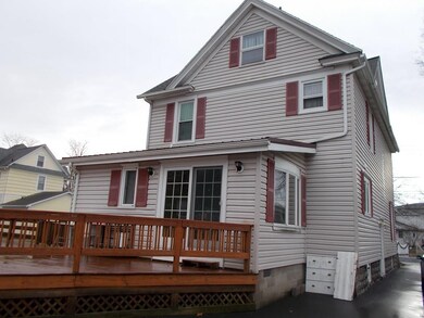 Huge deck area at back of home with sliding doors 