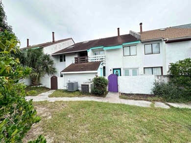 Rear view of property with a yard and central air 