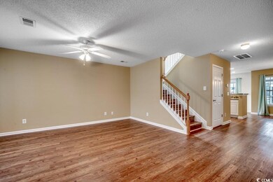 Spare room featuring visible vents, wood finished 
