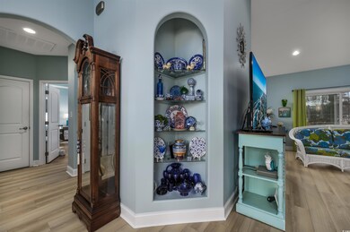 Corridor with light hardwood / wood-style floors a
