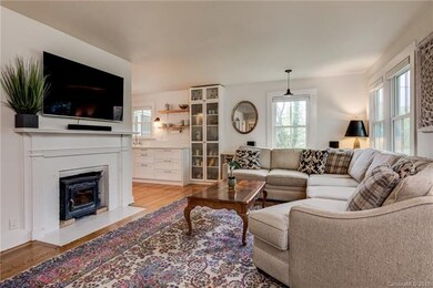 Living room features wood stove and opens on to mo