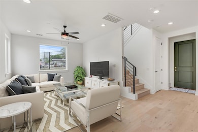 Living room featuring light wood-style floors, re