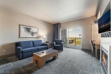 Carpeted living area featuring baseboards and a gl
