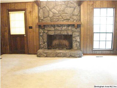 Great room with stone fireplace has gas starter an