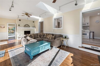 Living room with ceiling fan, rail lighting, and d