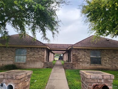 Ranch-style home featuring roof with shingles, brick siding, and a front yard
