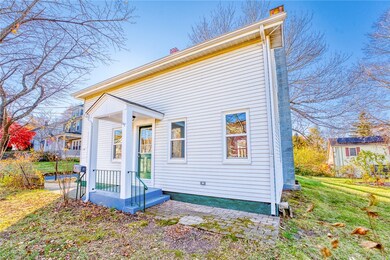 Front side view of house with covered entry.