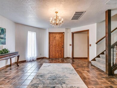Entrance foyer featuring an inviting chandelier, d