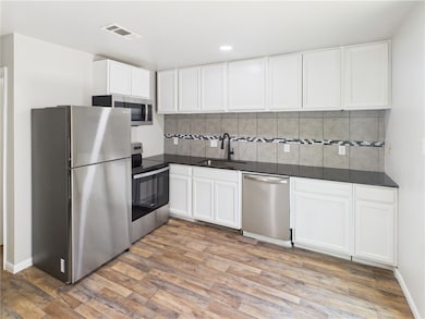 Kitchen with stainless steel appliances, a sink, d