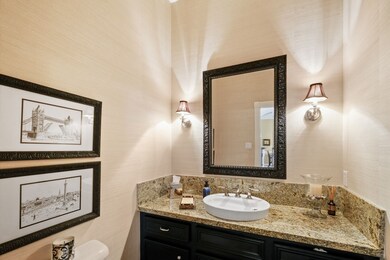 Elegant powder room just off the entry by the 