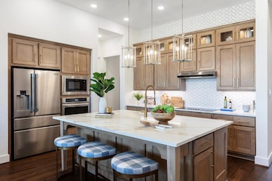 Kitchen with an island with sink, under cabinet r