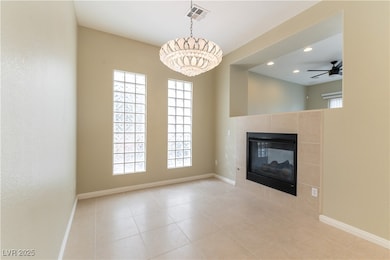 Unfurnished living room with a tiled fireplace, a