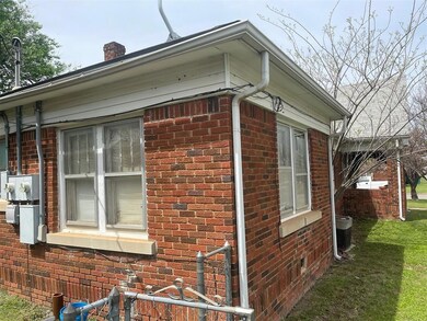 View of property exterior featuring a yard and coo
