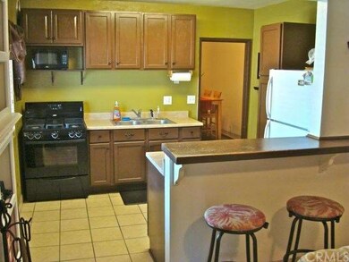 Kitchen with bar counter and open to family room.