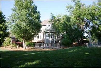Back view of home wrapped with beautiful trees and