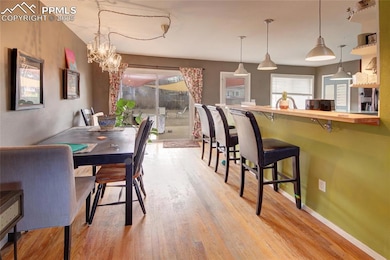 Dining room with baseboards, wood finished floors,