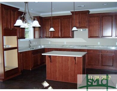 Kitchen. Kitchen has cabinets galore, island, desk