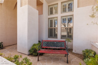 Doorway to property featuring stucco siding