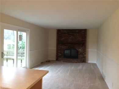 Family room with fireplace. Slider leads to Deck l