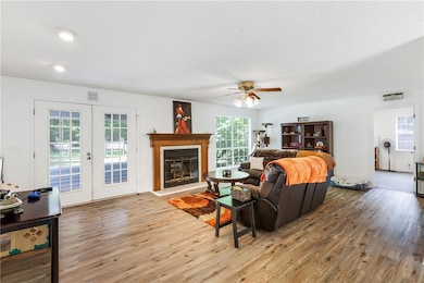 Living room with french doors, visible vents, ligh
