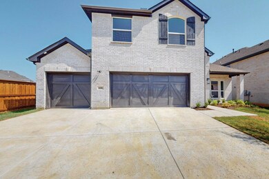View of front facade featuring a garage