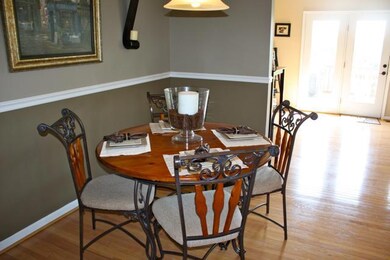 Dining area off kitchen with crown molding and chair rail. Such a perfect floor plan for entertaining!