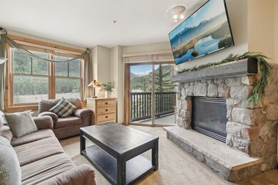 Living area featuring carpet floors and a stone fi