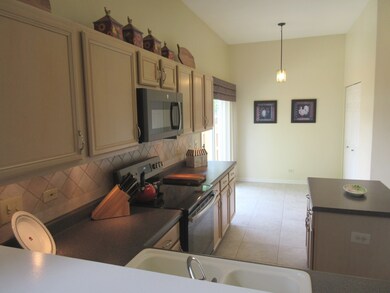Kitchen featuring vaulted ceilings with new GE sla