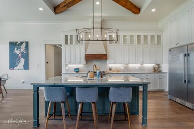 Kitchen with beam ceiling, premium range hood, hig
