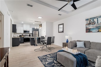 Living area with recessed lighting, ceiling fan, light wood finished floors, and visible vents