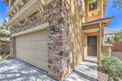 Property entrance featuring a garage, stone siding