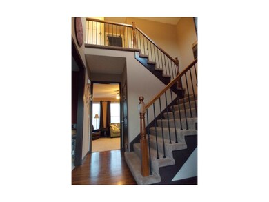 GRAND ENTRANCE WITH WROUGHT IRON SPINDLES ON STAIR