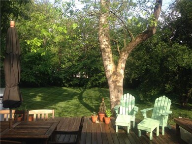 Large back yard with amazing trees and large deck for entertaining.