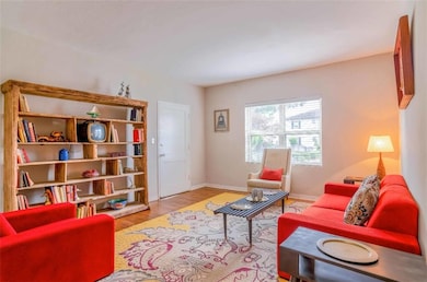 Living room with hardwood / wood-style flooring